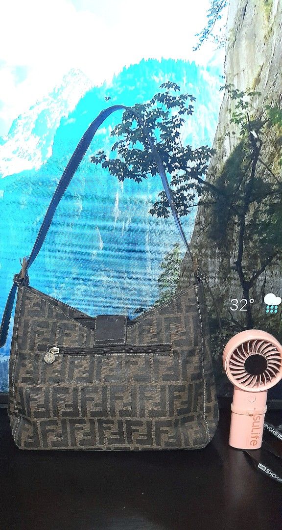 Fendi Hobo Soho Bag (Category: Luxury Bags & Wallets) located in Valenzuela. Submitted by muralungs101 (Listing ID 1404417081, Image 2). Description: NO CODE gold under zip only not ykk zip material: fabric nylon canvas Fendi shoulder bag with the iconic FF logo print. Features a brown leather strap and buckle and full zipper closure. The interior has three compartments. Made in Italy. issue: faded hardwares issue : there is a flaw on the back si