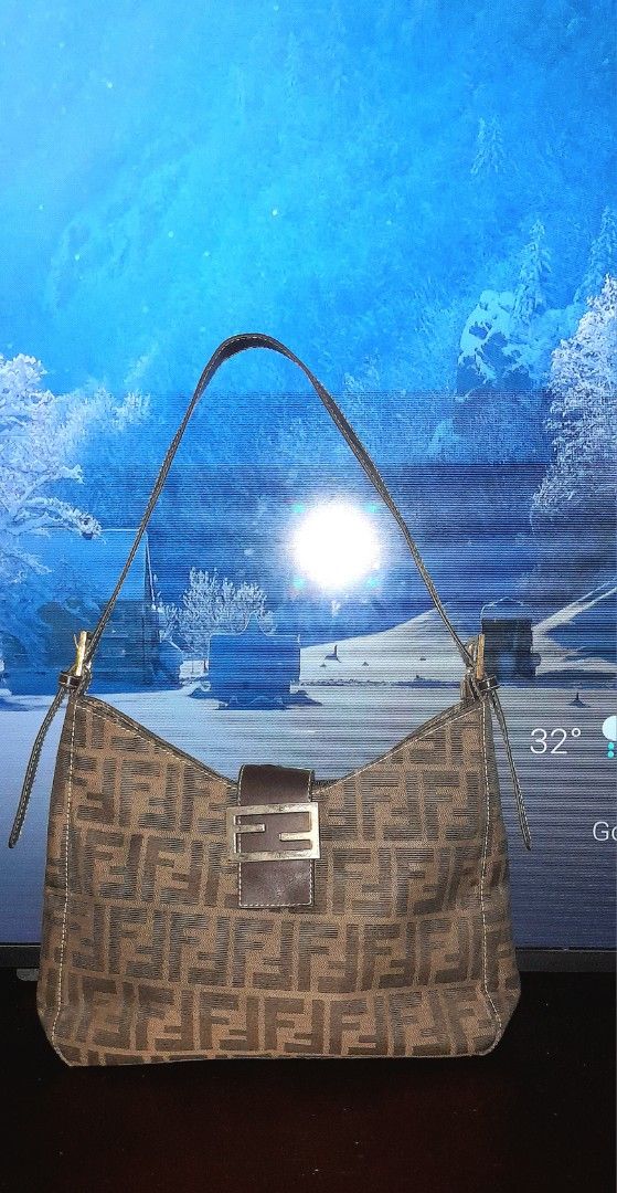Fendi Hobo Soho Bag (Category: Luxury Bags & Wallets) located in Valenzuela. Submitted by muralungs101 (Listing ID 1404417081, Image 1). Description: NO CODE gold under zip only not ykk zip material: fabric nylon canvas Fendi shoulder bag with the iconic FF logo print. Features a brown leather strap and buckle and full zipper closure. The interior has three compartments. Made in Italy. issue: faded hardwares issue : there is a flaw on the back si