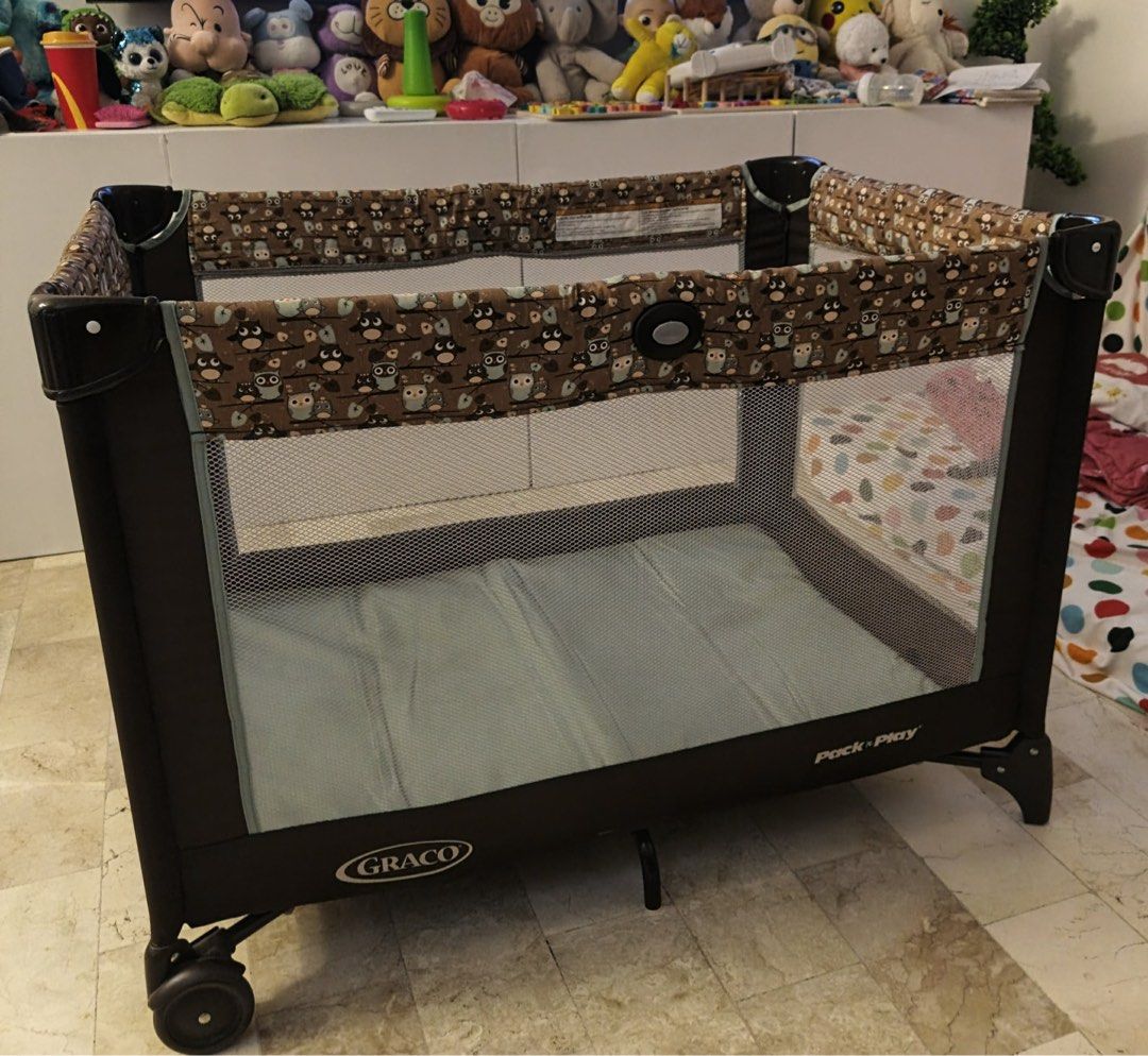 Graco Pack 'n Play Playard (Category: Cots & Cribs) located in Manila. Submitted by marcusandmagnus (Listing ID 1404459708, Image 1). Description: - Graco Pack 'n Play playard - Brown frame - Owl-patterned fabric - Mesh sides for visibility - Padded base - Wheels for easy movement - Perfect for keeping your baby safe and entertained.
