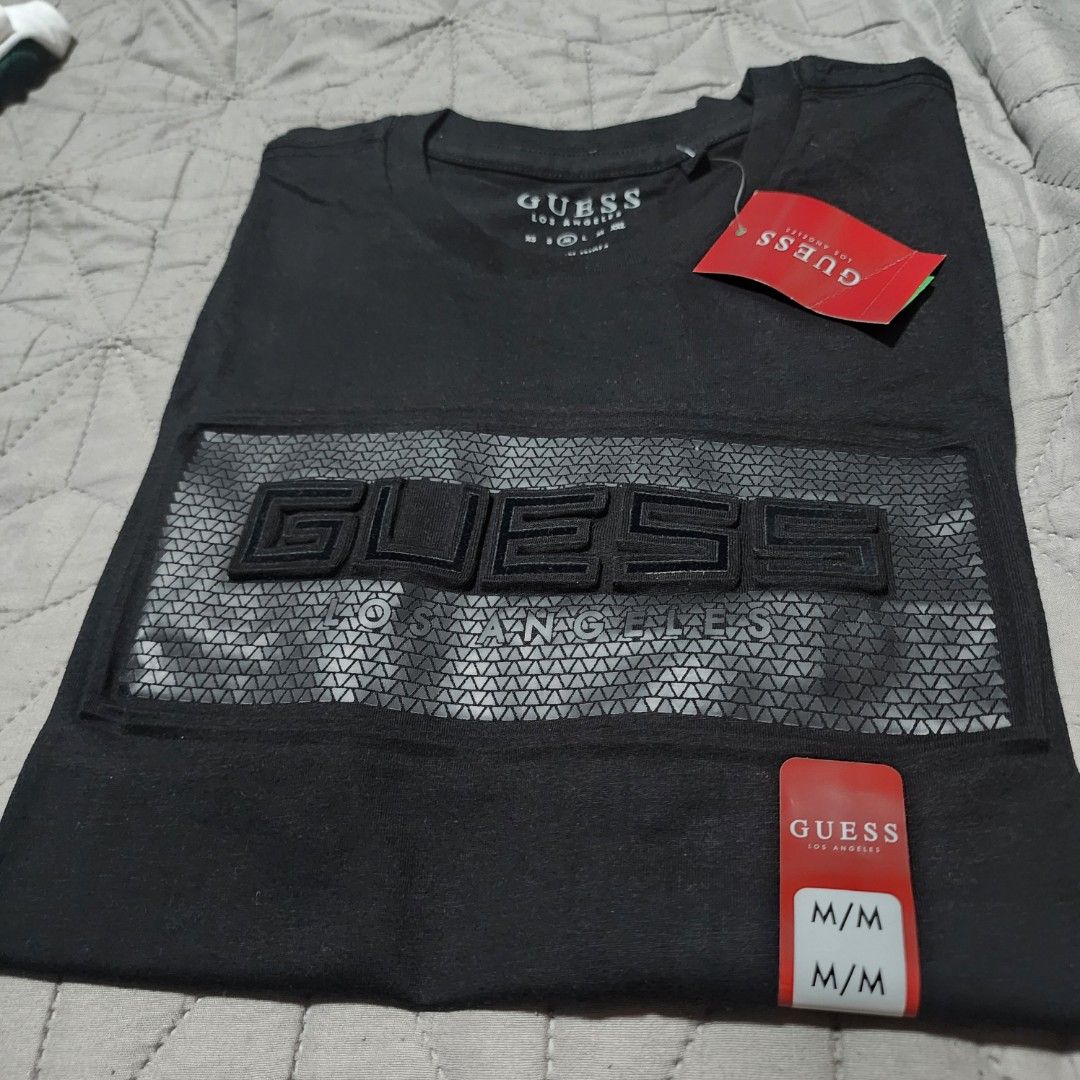 Guess Black T-shirt M/M (Category: Tshirts & Polo Shirts ) located in Manila. Submitted by zamken21 (Listing ID 1404520089, Image 2). Description: - Black Guess T-shirt - Size: M/M - Features a textured Guess logo - Classic crew neck design - Short sleeves - Unworn condition Brandnew Original Guess US Canada Size Large W20 L27.5 No Paper bag Manila area.