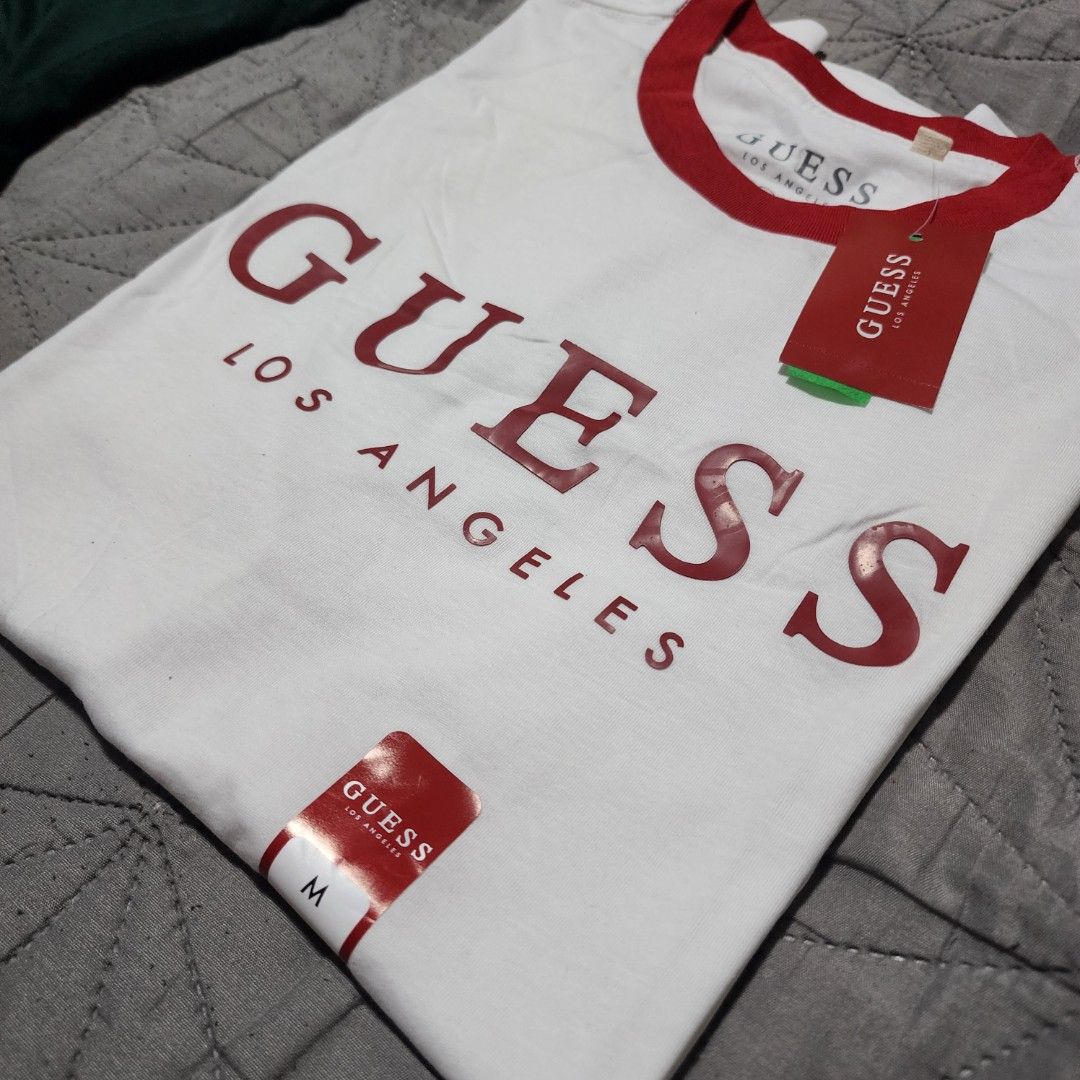Guess Los Angeles T-shirt - Medium (Category: Tshirts & Polo Shirts ) located in Manila. Submitted by zamken21 (Listing ID 1404519101, Image 1). Description: - Guess Los Angeles t-shirt - Red collar and accents - Guess logo on front - Size: Medium - Brand new with original tags Brandnew Original Guess US Canada Size Medium W20 L27.5 No Paper bag Manila area.