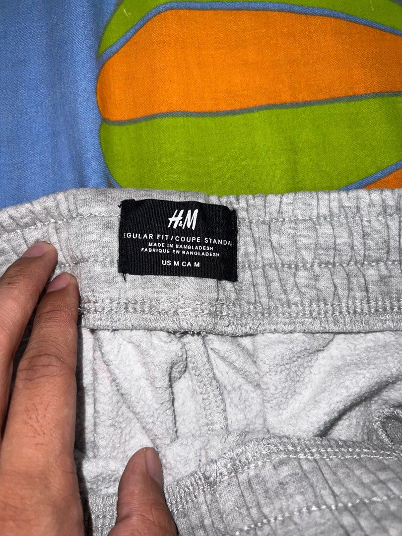 H&M Regular Fit Sweatpants - Medium (Category: Joggers) located in Paranaque City. Submitted by 2vy8ytgj8n (Listing ID 1404430538, Image 3). Description: - H&M gray sweatpants - Size: Medium - Features: Drawstring waist, cuffed ankles - Material: Soft - Condition: Good, no major flaws - Perfect for casual wear - Comfortable and stylish.