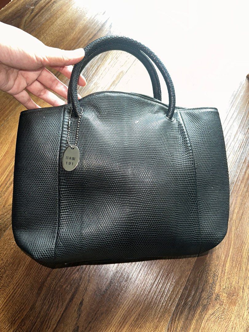 JRA Black Leather Handbag (Category: Luxury Bags & Wallets) located in Mandaluyong City. Submitted by TheWeekendProject (Listing ID 1404443721, Image 1). Description: - Black leather handbag - Textured exterior - Has its signature JRA metal tag - Two handles - Multiple compartments, including zippered pockets - Metal feet on the bottom - Well-constructed - 11” x 10” x 3.5”.