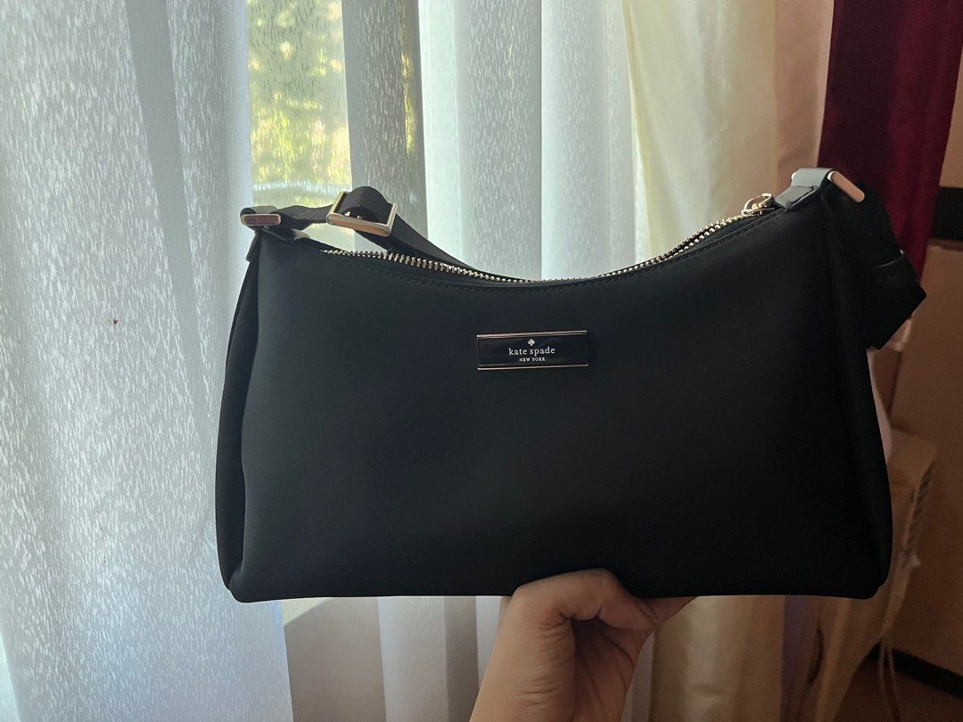 Kate Spade Carter Nylon Small Shoulder bag (Category: Luxury Bags & Wallets) located in Caloocan City. Submitted by buttercup28_ (Listing ID 1404447574, Image 1). Description: Kate Spade Carter Nylon Small Shoulder bag Length: 11.2" Height: 6.5" Width: 4.0" 100% Recycled Nylon Trim: Lambskin PU trim 2 Way Script Logo Lining Strap drop: 15.75" at longest Features: - Interior back zip pokcet - Zip closure - Fits Large Continental Wallet - KSNY Meta