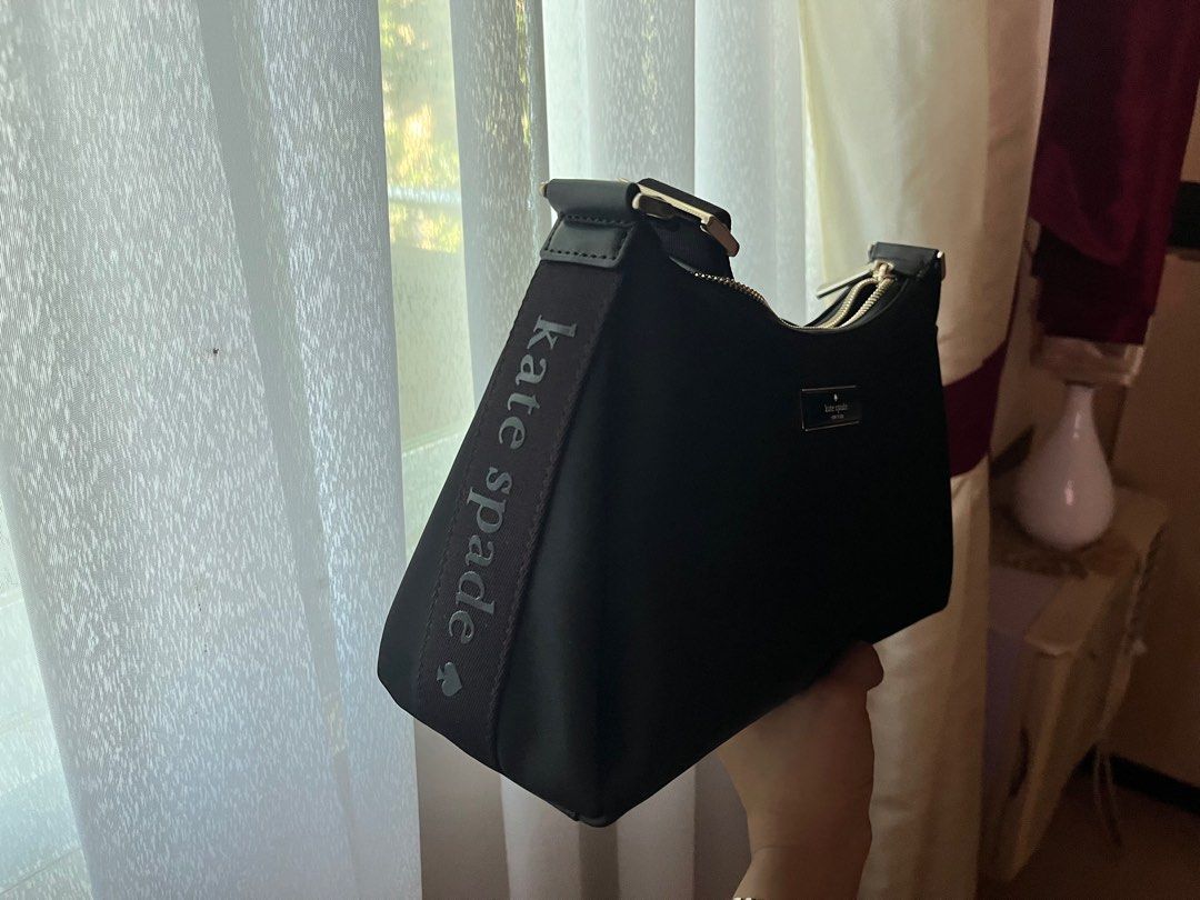 Kate Spade Carter Nylon Small Shoulder bag (Category: Luxury Bags & Wallets) located in Caloocan City. Submitted by buttercup28_ (Listing ID 1404447574, Image 2). Description: Kate Spade Carter Nylon Small Shoulder bag Length: 11.2" Height: 6.5" Width: 4.0" 100% Recycled Nylon Trim: Lambskin PU trim 2 Way Script Logo Lining Strap drop: 15.75" at longest Features: - Interior back zip pokcet - Zip closure - Fits Large Continental Wallet - KSNY Meta