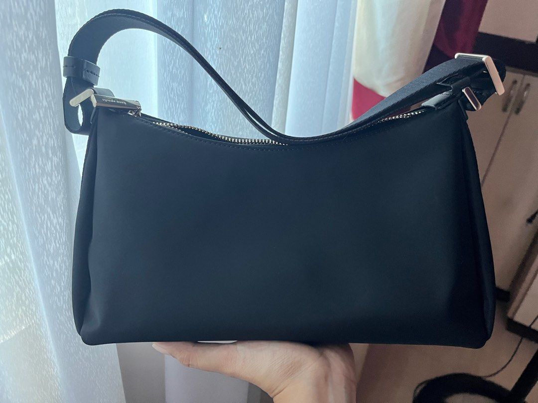 Kate Spade Carter Nylon Small Shoulder bag (Category: Luxury Bags & Wallets) located in Caloocan City. Submitted by buttercup28_ (Listing ID 1404447574, Image 3). Description: Kate Spade Carter Nylon Small Shoulder bag Length: 11.2" Height: 6.5" Width: 4.0" 100% Recycled Nylon Trim: Lambskin PU trim 2 Way Script Logo Lining Strap drop: 15.75" at longest Features: - Interior back zip pokcet - Zip closure - Fits Large Continental Wallet - KSNY Meta
