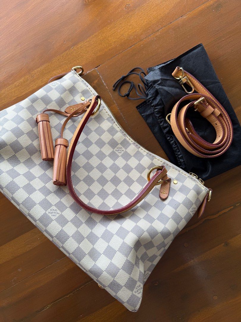 Louis Vuitton Damier Azur Canvas Handbag (Category: Luxury Bags & Wallets) located in Iloilo. Submitted by imnolittlej (Listing ID 1404442211, Image 1). Description: - Authentic Louis Vuitton Damier Azur handbag - Zip closure - Interior pockets - Detachable shoulder strap - Includes two leather tassels - Includes provided dust bag - Light pink interior lining - Gold-toned hardware - Date code: SD0168.