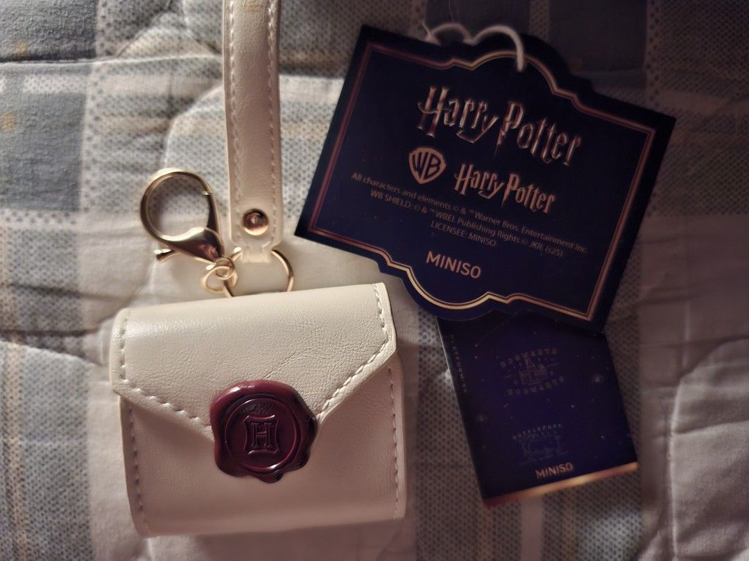 Miniso Harry Potter Earpods Case (Category: Earphones) located in Naguilian. Submitted by lieph26057 (Listing ID 1404509353, Image 1). Description: Harry Potter Earpods Case Brand new, never used. - Cream-colored exterior. - Red wax seal detail. - Gold clasp on strap. - Cream interior with snap closure. - Comes with tag. Notes: ♡ First to pay basis~ ♡ Item will marked sold once item is received ♡ Shipping via Jnt. ♡ Gcash Payment - No rush shippi