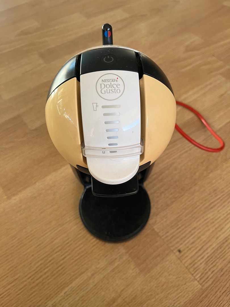 Nescafe Dolce Gusto Coffee Machine (Category: Coffee Machines & Makers) located in Subic. Submitted by malojod2334612 (Listing ID 1404457373, Image 3). Description: - Nescafe Dolce Gusto coffee machine. - Clear water reservoir. - User-friendly design. - Black and beige color scheme. - Includes power cord. - Perfect for home coffee brewing..