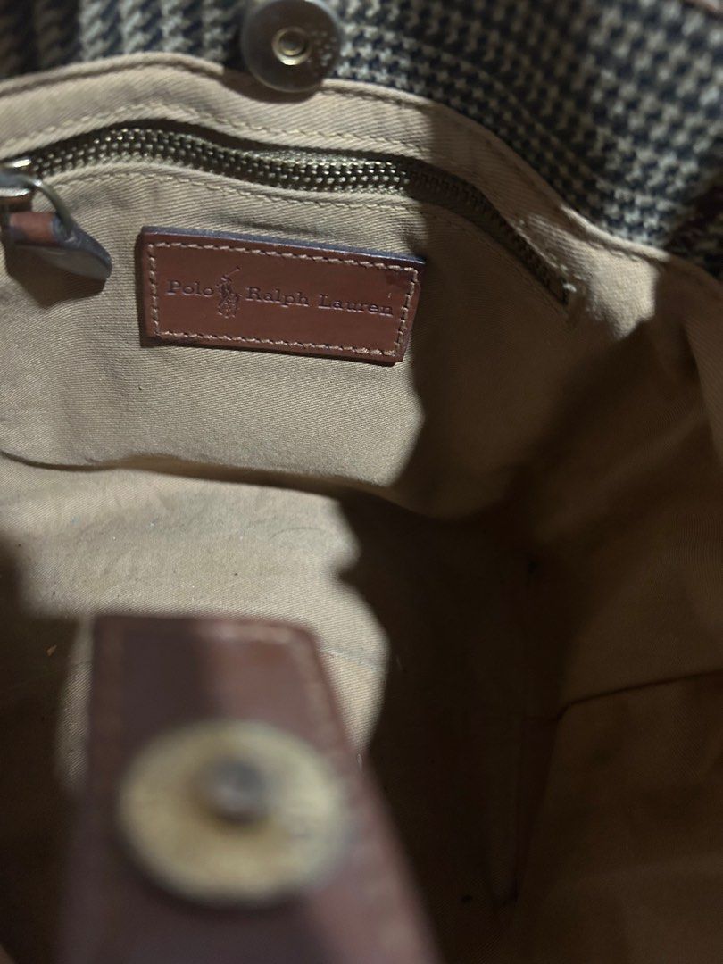 Polo Ralph Lauren Tote Bag (Category: Luxury Bags & Wallets) located in Quezon City. Submitted by zaria22 (Listing ID 1404518688, Image 2). Description: - Polo Ralph Lauren vintage tote bag - Classic plaid pattern - Brown leather straps and trim - Interior zippered pocket - Gold-toned brand plate - Rectangular shape - Includes brand label - Still in good usable condition, with expected signs of wear due to age and normal use..