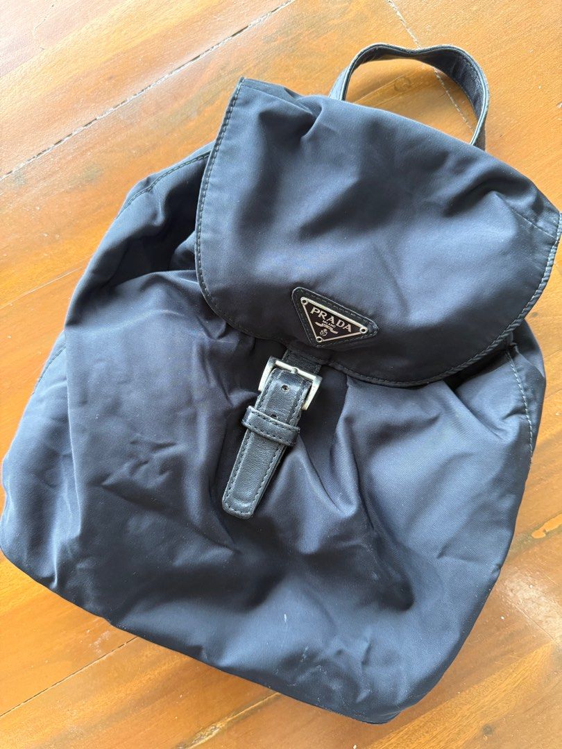 Prada Black Nylon Backpack with Chain Straps (Category: Luxury Bags & Wallets) located in Iloilo. Submitted by imnolittlej (Listing ID 1404444629, Image 2). Description: - Authentic Prada backpack - Black nylon material - Chain straps (silver-toned) - Flap closure with buckle - Small Prada logo - Top handle and drawstring closure - Interior zipper.
