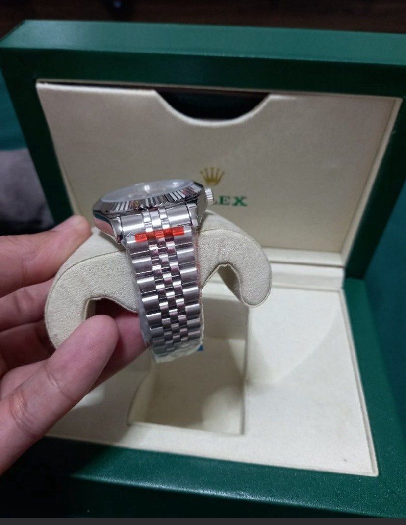 Rolex Datejust Silver Dial (Category: Luxury Watches) located in Pasig City. Submitted by ggc888 (Listing ID 1404416490, Image 2). Description: - Rolex Datejust - Silver dial - Fluted bezel - Jubilee bracelet - Original green Rolex box included - Date display at 3 o'clock - Bracelet with protective plastic.