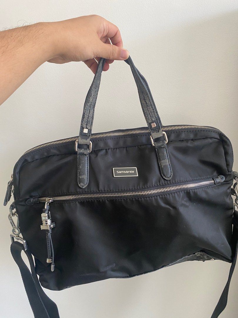 Samsonite Black Handbag (Category: Luxury Bags & Wallets) located in Paranaque City. Submitted by joseg33 (Listing ID 1404408768, Image 1). Description: - Black Samsonite handbag - Includes a detachable shoulder strap - Features a top handle - Zipper closure - Silver Samsonite logo - Shows wear on handles and shoulder strap.