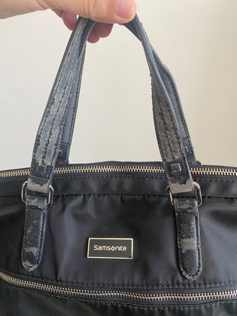 Samsonite Black Handbag (Category: Luxury Bags & Wallets) located in Paranaque City. Submitted by joseg33 (Listing ID 1404408768, Image 2). Description: - Black Samsonite handbag - Includes a detachable shoulder strap - Features a top handle - Zipper closure - Silver Samsonite logo - Shows wear on handles and shoulder strap.