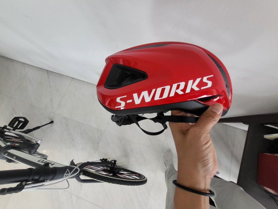 Specialized S-Works Road Bike Helmet - Red (Category: Parts & Accessories) located in Singapore. Submitted by leeqah (Listing ID 1404473030, Image 1). Description: Features a vibrant red color with the S-Works logo. Provides great ventilation and protection. Perfect for road cycling. Selling because it's no use..