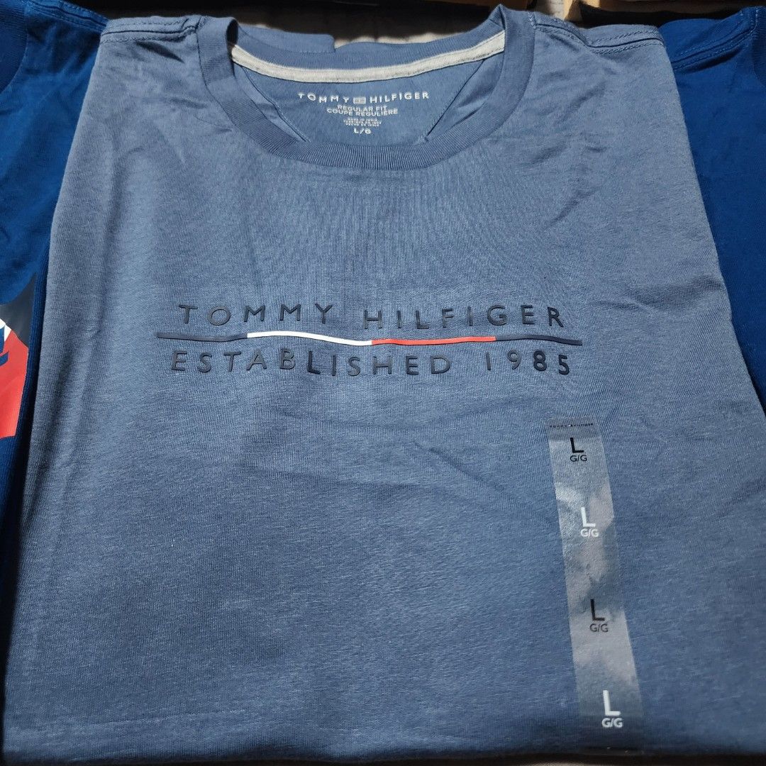 Tommy Hilfiger Blue T-Shirt - Large (Category: Tshirts & Polo Shirts ) located in Manila. Submitted by zamken21 (Listing ID 1404522864, Image 2). Description: Tommy Hilfiger blue t-shirt, size Large, new with tags. Features the Tommy Hilfiger logo. Crew neck, short sleeves. Brandnew US Canada Size Large W21 L28.5 No Paper bag Manila area.