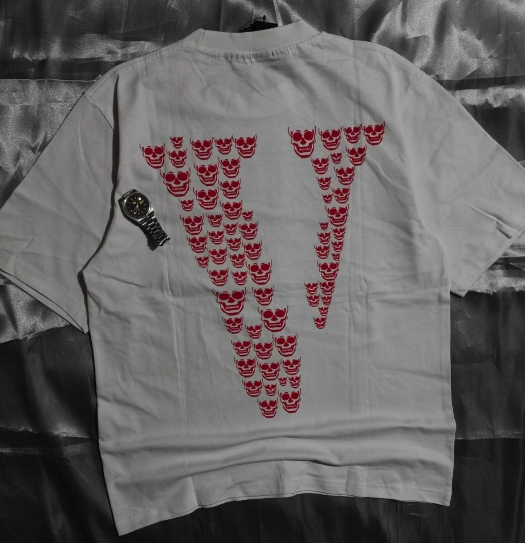 Vlone T-shirt (Category: Tshirts & Polo Shirts ) located in Taguig. Submitted by marked_item (Listing ID 1404538490, Image 2). Description: - Vlone T-shirt - Front graphic with brand name and design - Back features V-shaped skull design - Short sleeves - Crew neck - Standard fit.
