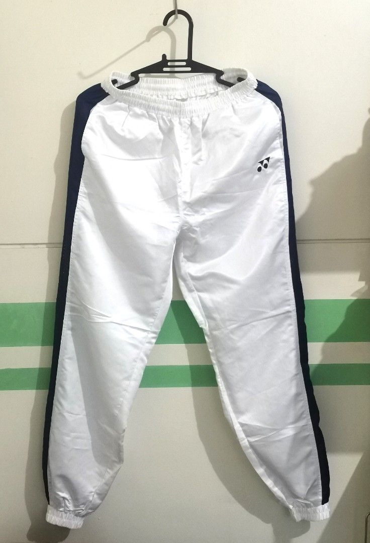 Yonex Track Pants - White and Navy (Category: Joggers) located in San Pablo. Submitted by somariaj (Listing ID 1404443312, Image 1). Description: - Yonex track pants - Color: White with navy blue side stripes - Features: Front zipper, elastic waistband - Material: 100% polyester - Visible Yonex logo - JASPO product 26-36x41.
