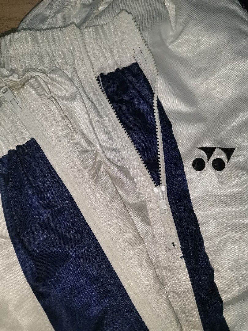 Yonex Track Pants - White and Navy (Category: Joggers) located in San Pablo. Submitted by somariaj (Listing ID 1404443312, Image 3). Description: - Yonex track pants - Color: White with navy blue side stripes - Features: Front zipper, elastic waistband - Material: 100% polyester - Visible Yonex logo - JASPO product 26-36x41.