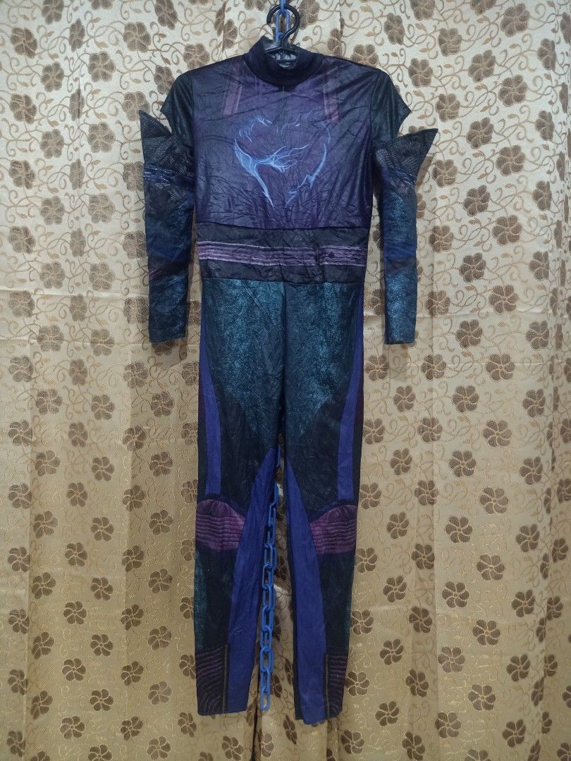 Descendants 3 Mal Costume (Category: Babies & Kids Fashion) located in Cavite. Submitted by nobledeer_10a275_598 (Listing ID 1404611887, Image 1). Description: - Descendants 3 Mal costume - Full-body jumpsuit - High collar and long sleeves - Dark color scheme - Purple and blue accents - Detailed design on shoulders and knees - Costume is hanging on a hanger.