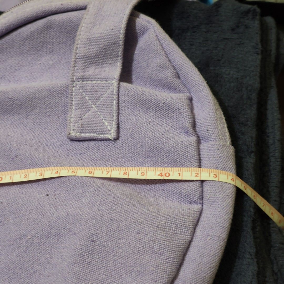 Heart Canvas Tote Bag - Purple (Category: Tote Bags) located in Muntinlupa City. Submitted by janemee (Listing ID 1404646507, Image 3). Description: - Heart-shaped design - Made of durable canvas - Spacious interior with zipper closure - Two convenient front pockets - Sturdy handles for comfortable carrying - Approximately 40cm wide - Stylish and functional for any outfit.