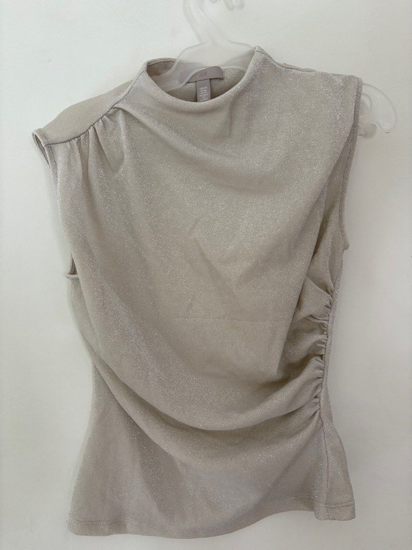 H&M Sleeveless Top - XS (Category: Sleeveless) located in Imus. Submitted by collset (Listing ID 1404634355, Image 1). Description: - H&M sleeveless top - Features a mock neck - Ruched detailing on the side - Shimmery, light beige color - Size XS.