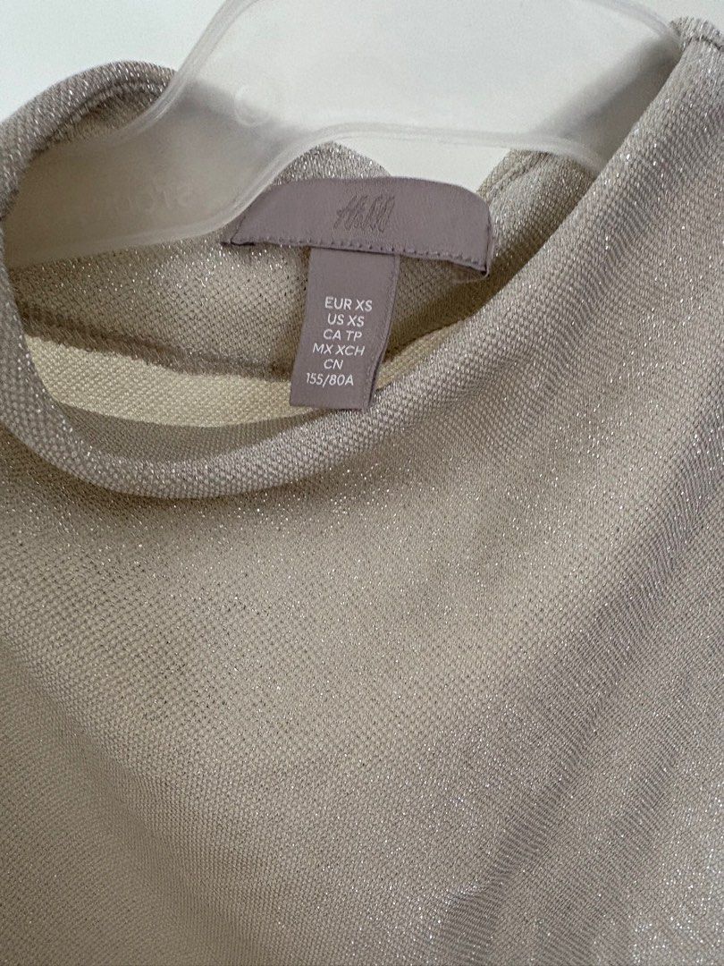 H&M Sleeveless Top - XS (Category: Sleeveless) located in Imus. Submitted by collset (Listing ID 1404634355, Image 3). Description: - H&M sleeveless top - Features a mock neck - Ruched detailing on the side - Shimmery, light beige color - Size XS.