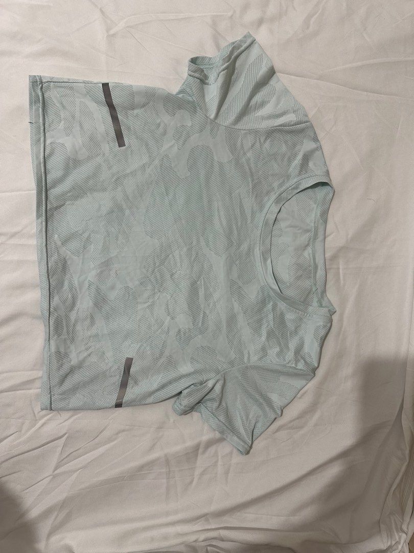 Light Blue Camo Short Sleeve Shirt (Category: Activewear) located in Manila. Submitted by kira.declutters (Listing ID 1404575816, Image 2). Description: - Light blue short sleeve shirt - Camo pattern - Reflective stripes on sleeves - Lightweight and breathable material - Crew neck - Comfortable fit - Ideal for workouts or casual wear.