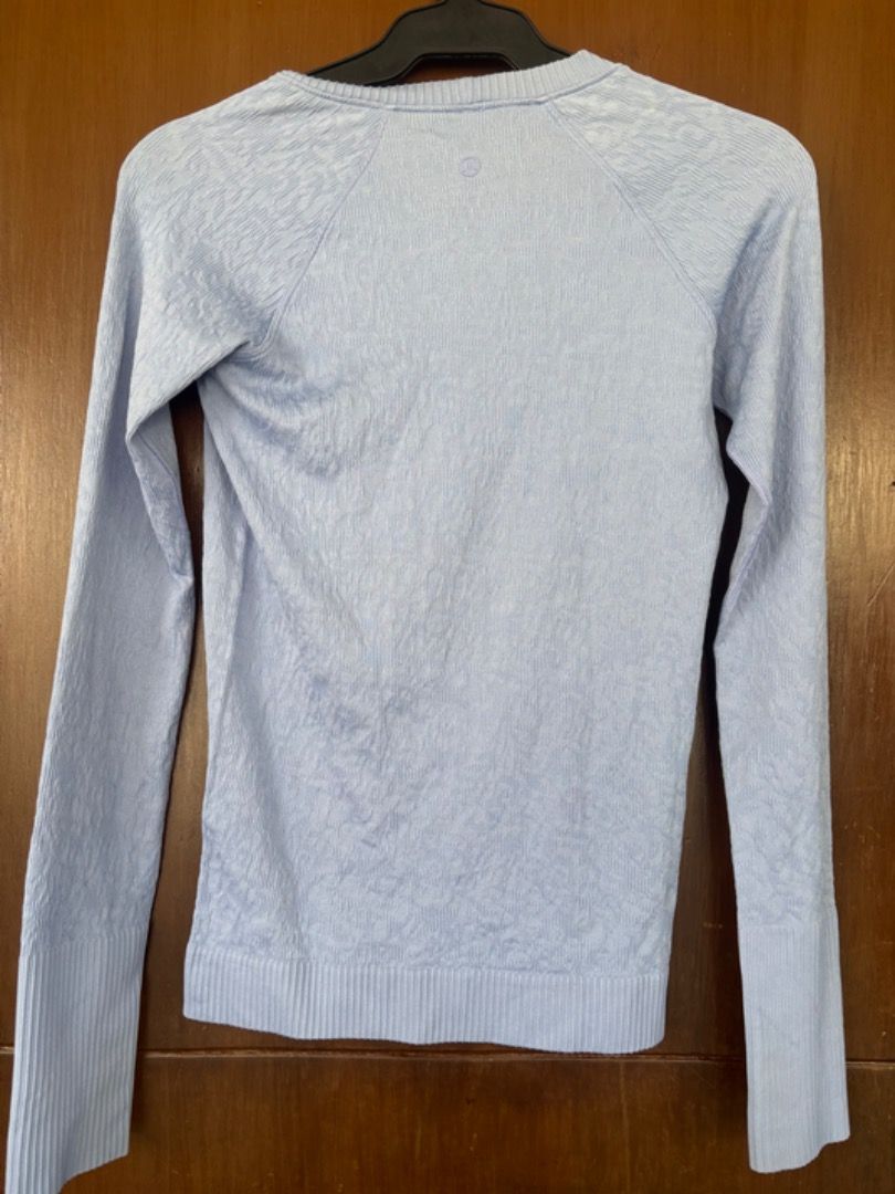 Lululemon SWIFTLY TECH LONG SLEEVE SHIRT - Size 4 (Category: Activewear) located in Paranaque City. Submitted by the_goodfind (Listing ID 1404616175, Image 2). Description: > Lululemon Swiftly Tech Long Sleeve Shirt > Looks pale in photos due to lighting, but really a vibrant light blue to lavender color (closest to Hydrangea Blue, see picture with model) > Size 4 > Made with nylon and elastane > Crew neck; long sleeves with ribbed cuffs; texture