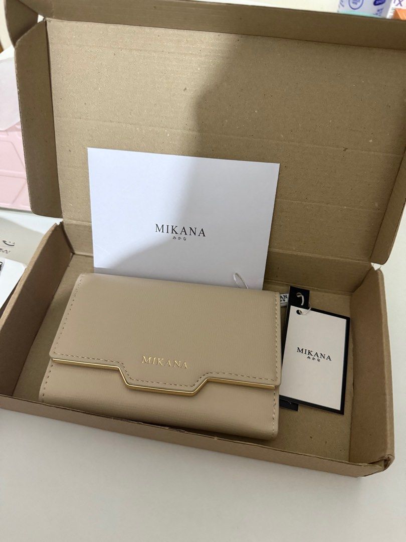 Mikana Miwako Trifold Short Wallet (Category: Wallets & Card holders) located in Taguig. Submitted by raninini (Listing ID 1404710131, Image 2). Description: - brand new Tri-fold wallet with gold snap button closure Material: PU Leather Dimension: 9.7 x 14 x 3.2cm Weight: 140g Colors available: Beige, Pink & Green INTERIOR: One full-length cash compartment Five card slots one zipper pocket .
