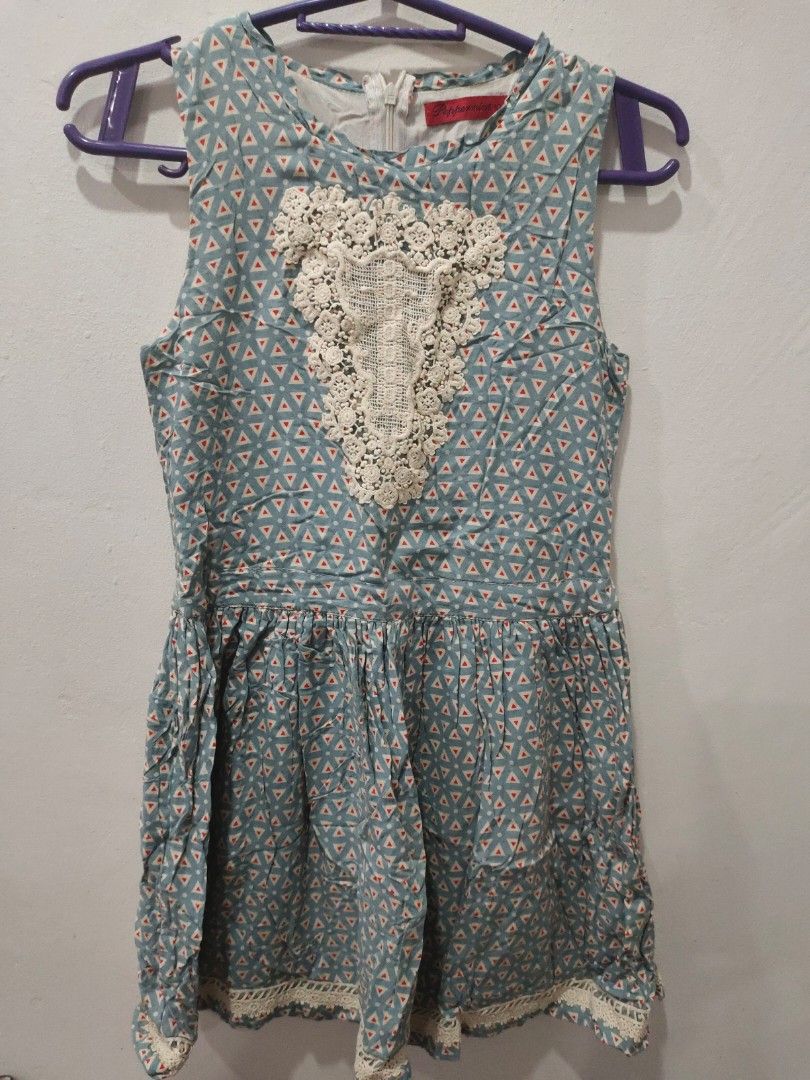 Peppermint Blue Geometric Dress with Lace (Category: Babies & Kids Fashion) located in Valenzuela. Submitted by annday (Listing ID 1404673216, Image 1). Description: - Blue geometric pattern with red triangle accents - Delicate white lace detail on bodice - Zipper closure at the back - Short sleeves - Fitted waist - Brand tag visible - Unique and stylish design.