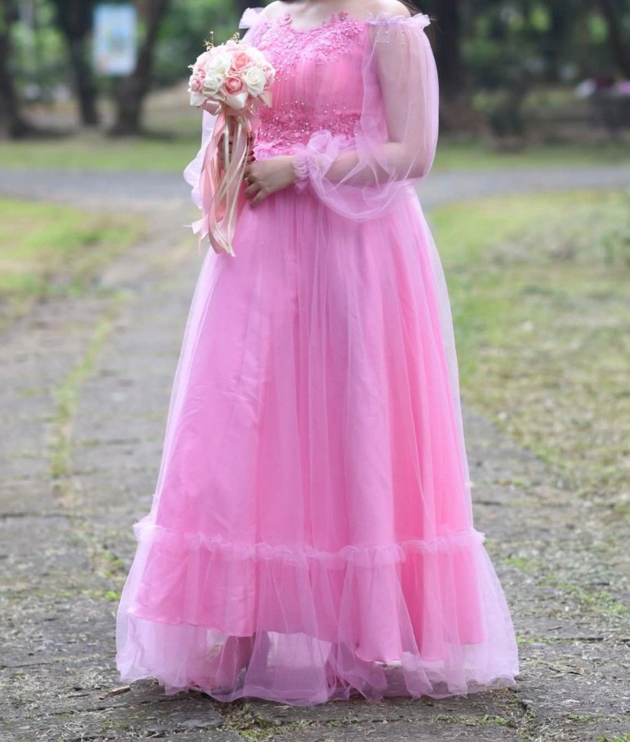 Pink Off-Shoulder Tulle Gown (Category: Evening dresses & gowns) located in Manila. Submitted by knm.studios (Listing ID 1404610053, Image 1). Description: WORE ONCE ONLY FOR DEBUT TEASER Clean and Good Condition can fit up to size XL, Perfect for debut, prom and any other special occasions ₱2000 only + SF - Pink off-shoulder fairy gown - Fitted bodice with floral embellishments - Sheer, puffy sleeves - Flowing tulle skirt (Bouquet not included) 