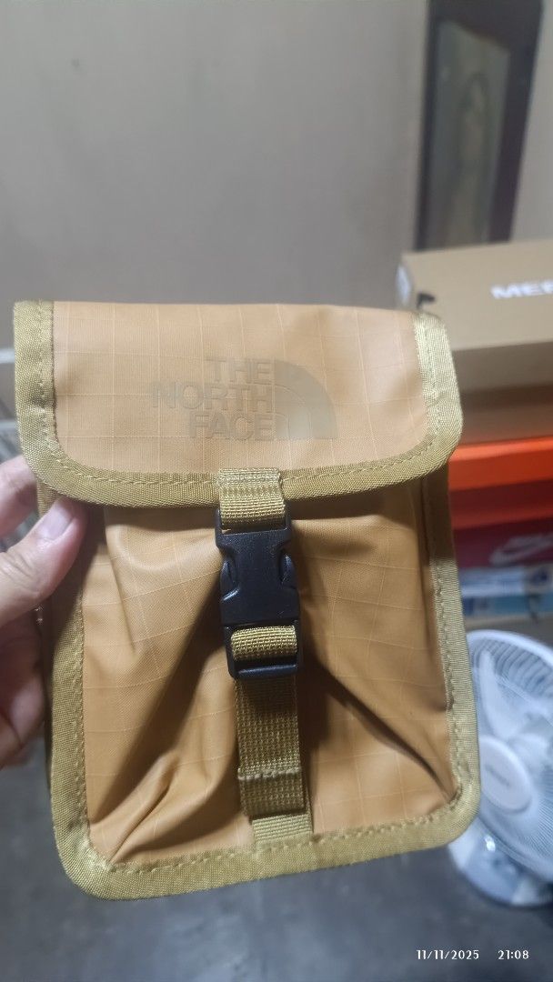 The North Face Pouch (Category: Belt bags, Clutches and Pouches) located in Rizal. Submitted by simplygoodthingsmel (Listing ID 1404618392, Image 1). Description: - The North Face tan pouch - Buckle closure - Strap with printed coordinates - Light gray interior - Carabiner clip - Durable, possibly water-resistant material - The North Face logo on front.