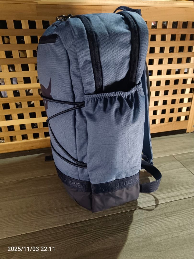 Under Armour Project Rock Brahma Backpack ( Blue ) (Category: Backpacks) located in Bacoor. Submitted by the.full.cart (Listing ID 1404720667, Image 2). Description: Under Armour Project Rock backpack features a blue design with the Project Rock logo. It has multiple compartments, including a top zip pocket and side pockets. The backpack includes adjustable straps and a top handle. The front of the bag has a bungee cord system. The bottom of the 