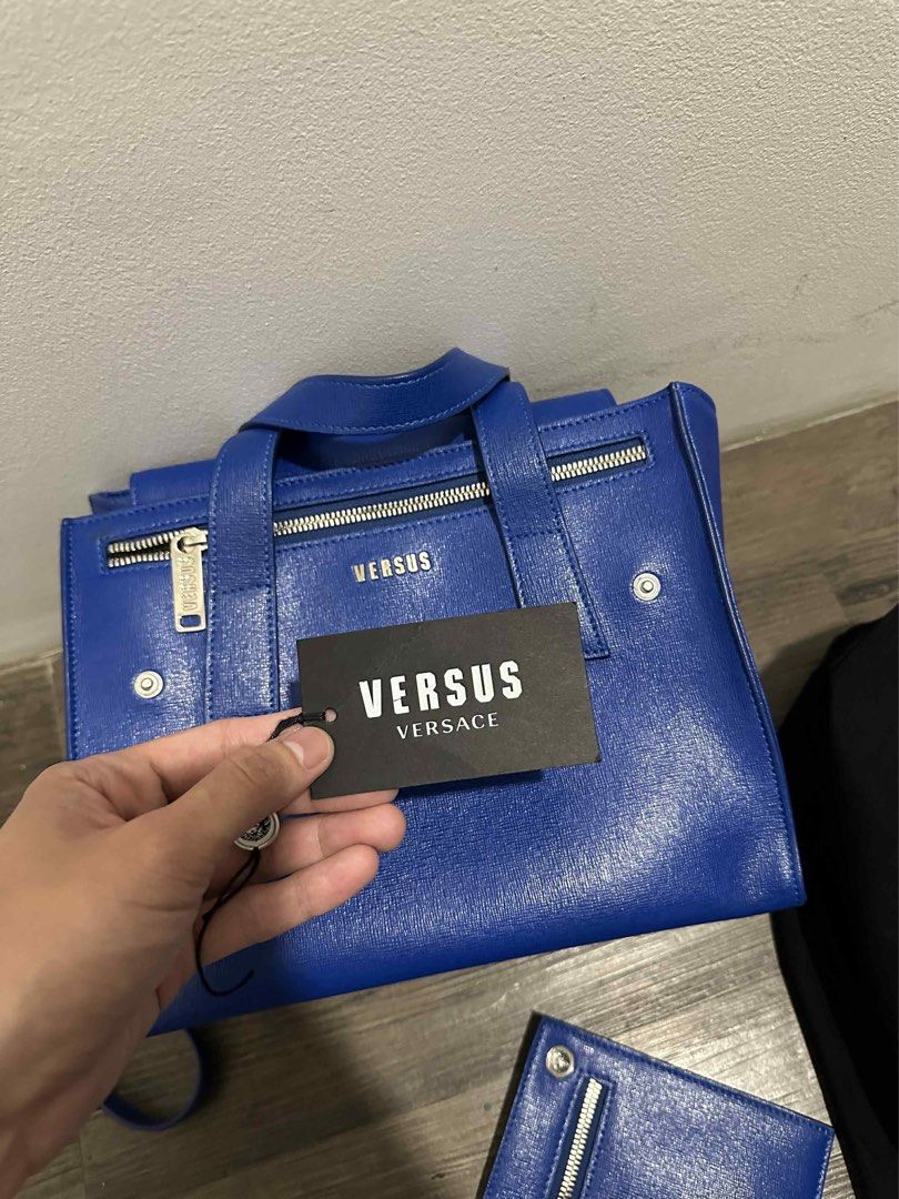 Versus Versace Blue Handbag Set (Category: Luxury Bags & Wallets) located in Santa Rosa. Submitted by imjzcarta (Listing ID 1404593329, Image 1). Description: - Versus by Versace handbag set - Vibrant blue color - Includes: - Tote bag with top handles and zip closure - Clutch with zip closure and Versace logo detail - Shoulder strap - Dust bag - Complete set with original accessories USED TWICE. MADE IN ITALY..