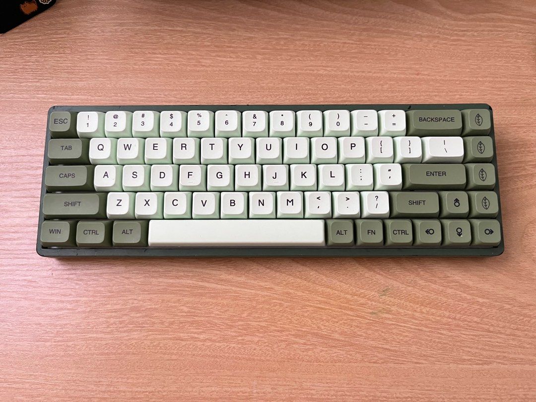 RK 65 Mechanical Keyboard, Matcha keycaps hotswapabble brown switch (Category: Computer Keyboard) located in Baras. Submitted by pwepreloved (Listing ID 1404805456, Image 1). Description: - 60% Mechanical Keyboard - Green and White Color Scheme - Compact Layout - Varying shades of green and white keycaps - Dark Green Frame - Minimalist Keycap Design.