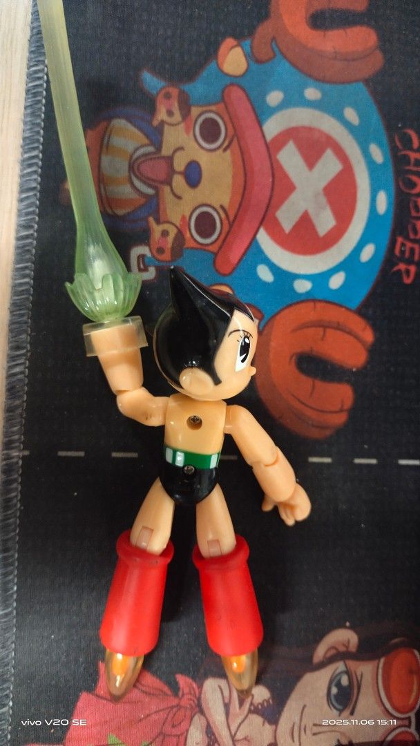 Astro Boy Action Figure (Category: Figurines & Statues) located in San Pedro. Submitted by thrifterspre-loved (Listing ID 1404924346, Image 3). Description: - Classic Astro Boy design - Features red boots and green chest - Includes a translucent green accessory - Dynamic pose - Articulated joints - no box.