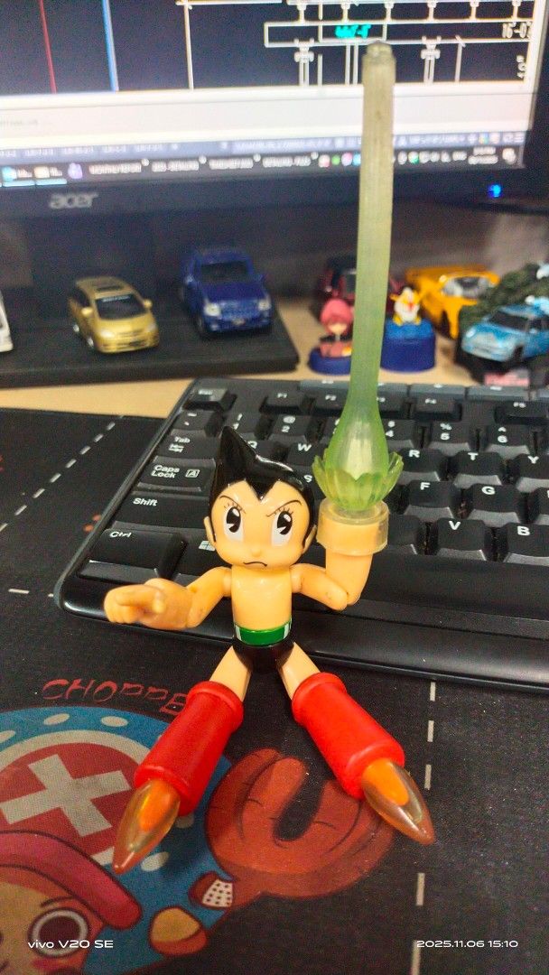 Astro Boy Action Figure (Category: Figurines & Statues) located in San Pedro. Submitted by thrifterspre-loved (Listing ID 1404924346, Image 2). Description: - Classic Astro Boy design - Features red boots and green chest - Includes a translucent green accessory - Dynamic pose - Articulated joints - no box.
