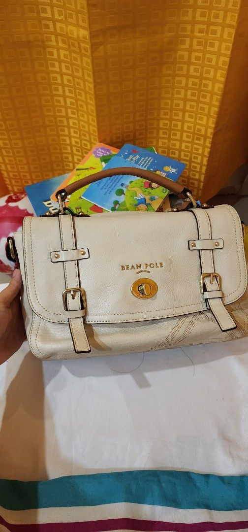 BeanPole White Handbag (Category: Luxury Bags & Wallets) located in Manila. Submitted by gingerific (Listing ID 1404942899, Image 1). Description: - Brand: Bean Pole - Color: White - Closure: Flap with buckle straps - Features: Top handle, gold-tone logo - Material: Leather.