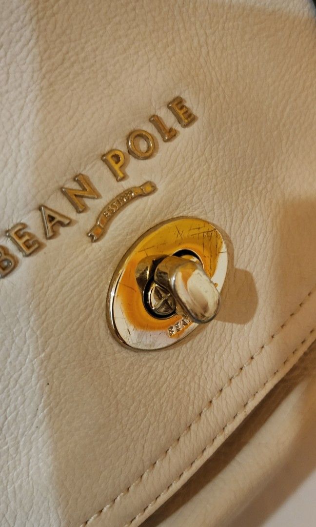 BeanPole White Handbag (Category: Luxury Bags & Wallets) located in Manila. Submitted by gingerific (Listing ID 1404942899, Image 2). Description: - Brand: Bean Pole - Color: White - Closure: Flap with buckle straps - Features: Top handle, gold-tone logo - Material: Leather.