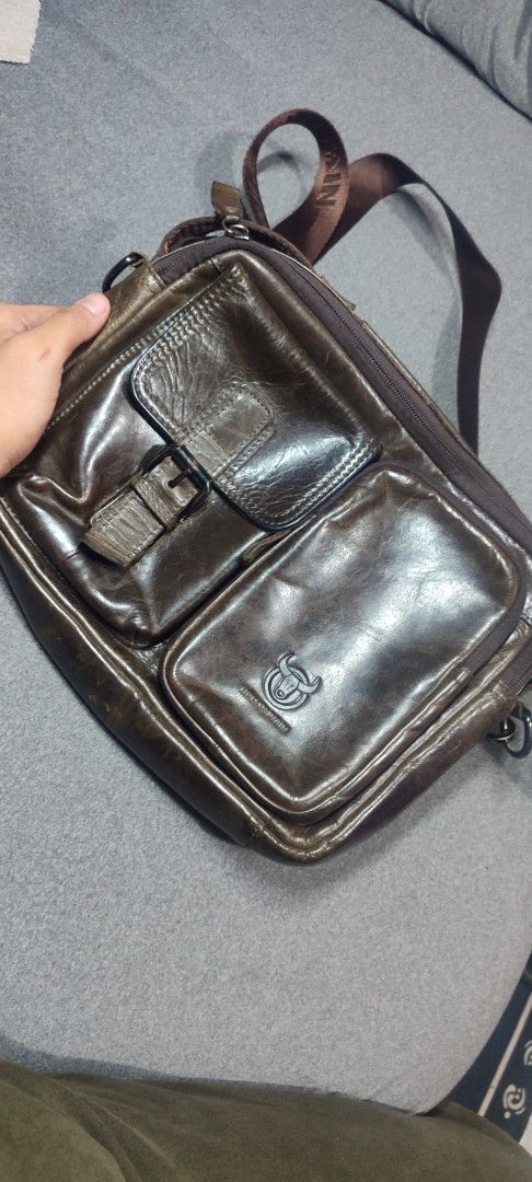 Bullcaptain Leather Messenger Bag (Category: Sling Bags) located in Rizal. Submitted by chicout (Listing ID 1404907212, Image 2). Description: - Bullcaptain brown leather messenger bag - Multiple compartments for storage - Two front pockets with buckle closure - Adjustable brown shoulder strap with brand name - Brand logo on the front - Branded tag inside - Ideal for daily use.