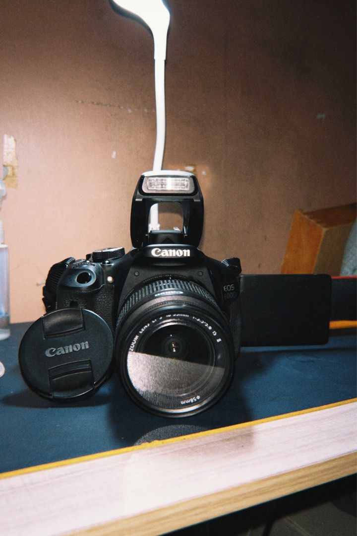 Canon EOS 600D DSLR Camera with Lens (Category: Cameras) located in Cebu City. Submitted by _____08_____ (Listing ID 1404827106, Image 1). Description: - RFS: hasn’t been used anymore (was for college) - Canon EOS 600D DSLR camera - 18-55mm lens included - Features a flip-out LCD screen - Built-in flash - Includes: lens cap, body cap, battery, charger, cables, cleaning cloth, and camera bag (rusty) - Comes with a camera strap - Issue: Last image 