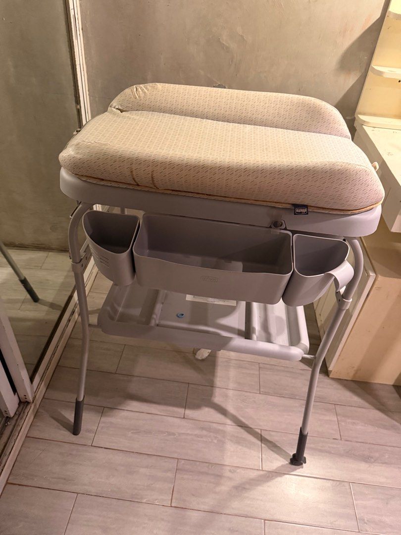 Chicco Baby Changing Table (Category: Other Baby Bathing & Changing Needs) located in Cavite. Submitted by kleaningoutmykloset (Listing ID 1404835703, Image 3). Description: NEGOTIABLE. Chicco baby changing table features a changing pad and a built-in baby bath. It has a sturdy frame with storage compartments for essentials. The table is designed with a neutral color scheme, making it suitable for any nursery..