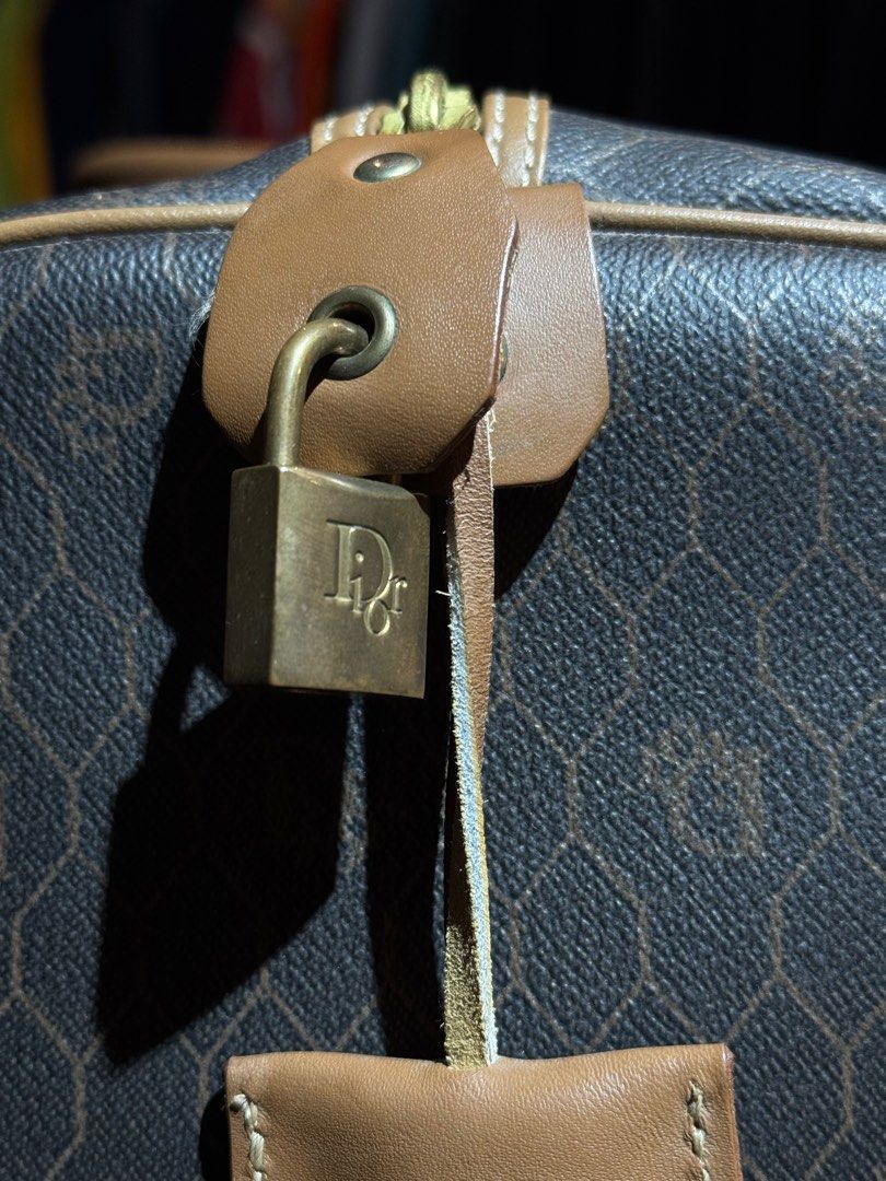Christian Dior Duffle Bag (Category: Luxury Bags & Wallets) located in Pasay City. Submitted by __allaboutgoods.ph (Listing ID 1404957039, Image 2). Description: - Vintage Christian Dior duffle bag - Brown monogram pattern - Tan leather accents - Features Dior logo lock - Top handle and zipper closure - Spacious design, ideal for travel.