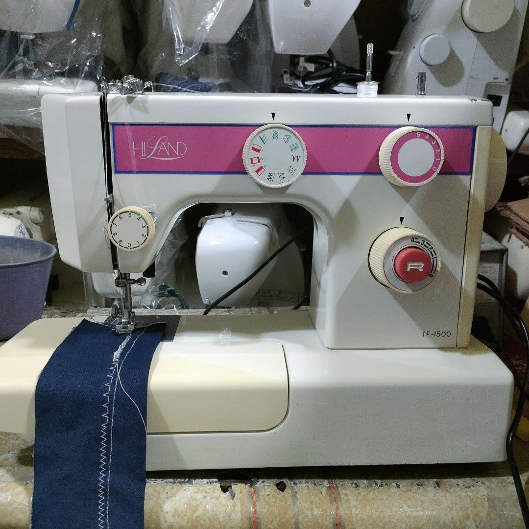 Hi-Land TF-1500 Sewing Machine (Category: Craft Supplies & Tools) located in Manila. Submitted by faststone-c3c8 (Listing ID 1404796065, Image 1). Description: Land TF-1500 sewing machine. Features a variety of stitch patterns and adjustable settings. Includes a foot pedal for hands-free operation. The machine is shown with a piece of fabric demonstrating its stitching capabilities. The model name is visible on the front of the machine..