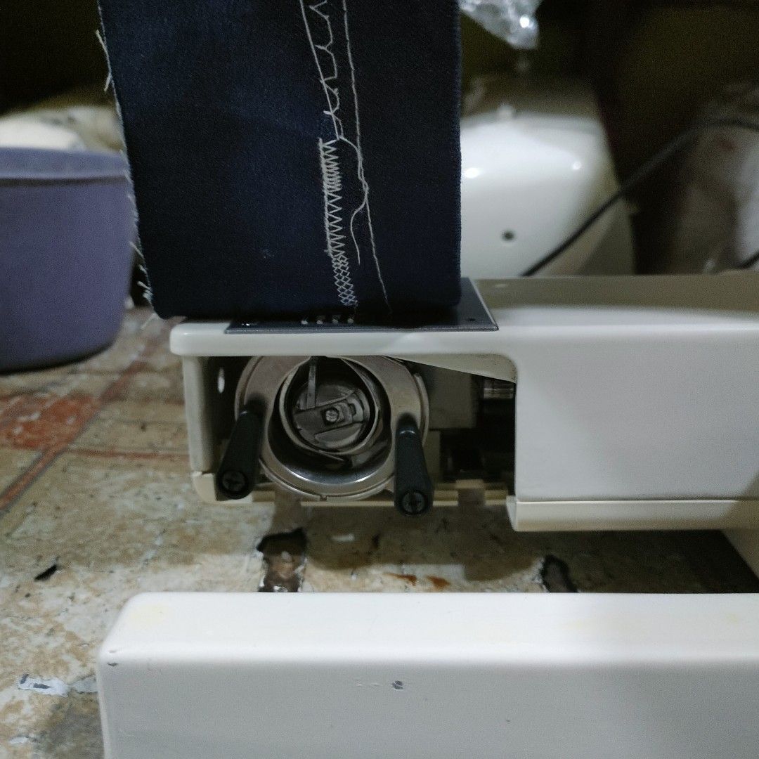 Hi-Land TF-1500 Sewing Machine (Category: Craft Supplies & Tools) located in Manila. Submitted by faststone-c3c8 (Listing ID 1404796065, Image 3). Description: Land TF-1500 sewing machine. Features a variety of stitch patterns and adjustable settings. Includes a foot pedal for hands-free operation. The machine is shown with a piece of fabric demonstrating its stitching capabilities. The model name is visible on the front of the machine..