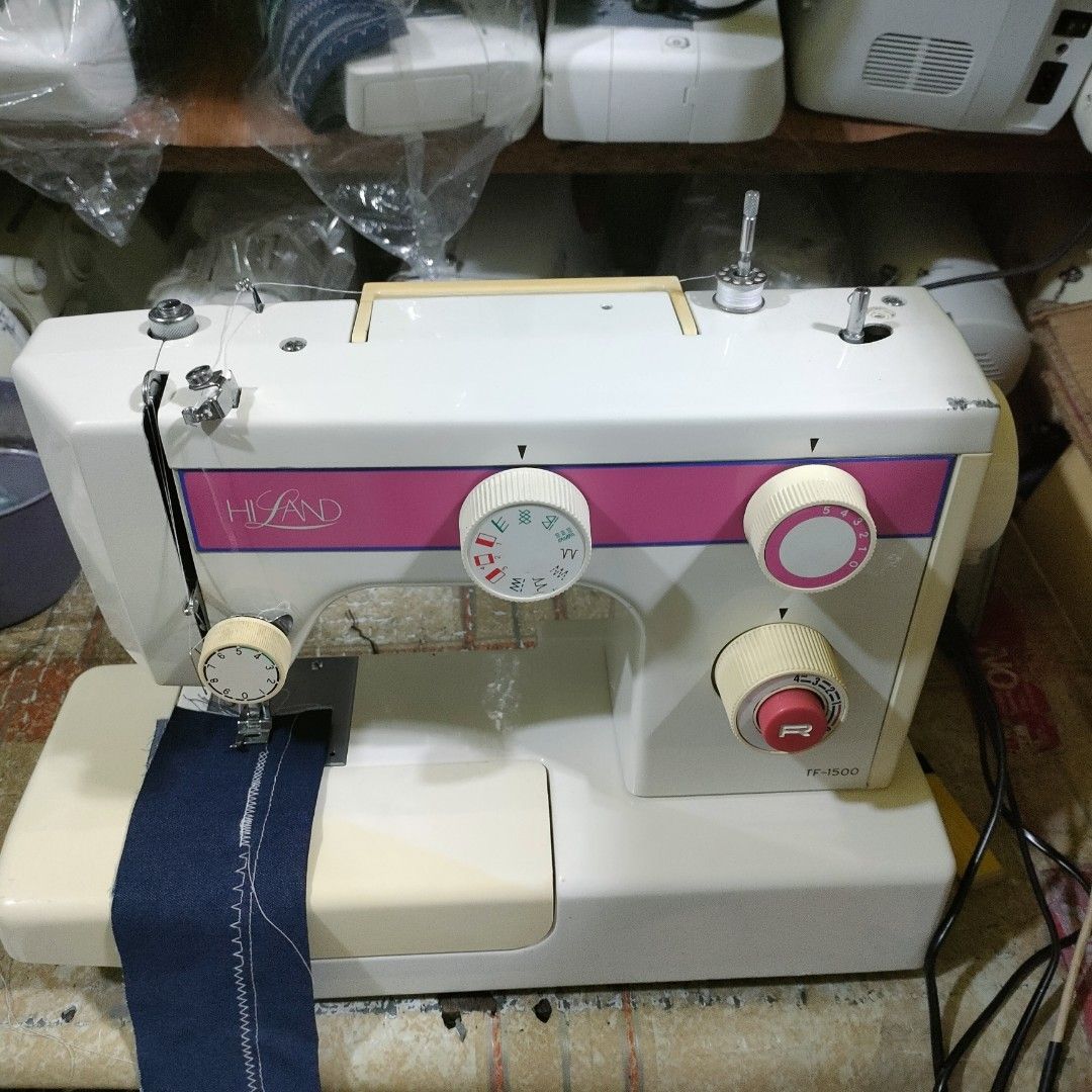 Hi-Land TF-1500 Sewing Machine (Category: Craft Supplies & Tools) located in Manila. Submitted by faststone-c3c8 (Listing ID 1404796065, Image 2). Description: Land TF-1500 sewing machine. Features a variety of stitch patterns and adjustable settings. Includes a foot pedal for hands-free operation. The machine is shown with a piece of fabric demonstrating its stitching capabilities. The model name is visible on the front of the machine..