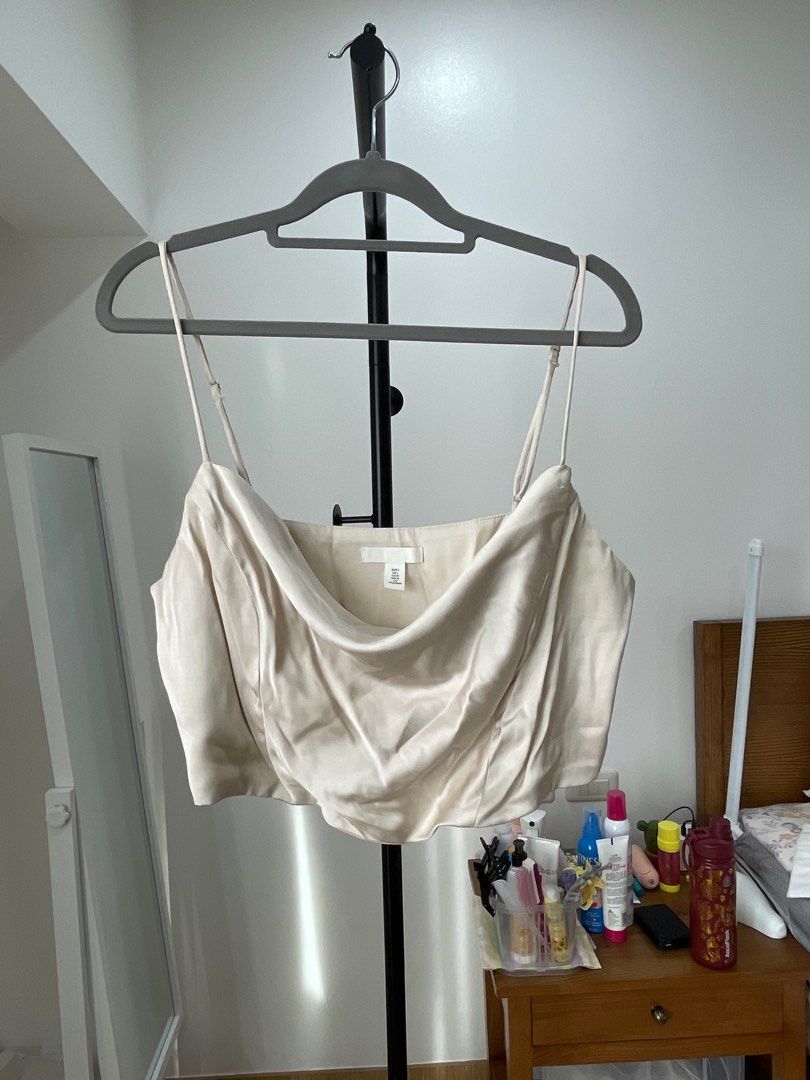 H&M Satin Cowl Neck Crop Top (Category: Sleeveless) located in Pasig City. Submitted by bcab93 (Listing ID 1404853482, Image 1). Description: - Has light plastic boning to help maintain the top’s structure while worn - Side invisible zip closure - Pretty champagne color - Minor defects shown in pictures (small runs in the fabric on the side of the top and some staining from the buckle on the back of the straps) - Further discounts can be given if