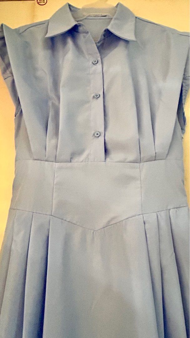 Light Blue Sleeveless Dress (Category: Dresses) located in Cavite. Submitted by xaleene (Listing ID 1404795800, Image 2). Description: - Light blue midi dress - Collared neckline - Button-down front - Fitted waist - Pleated skirt - Sleeveless design - Lightweight fabric - Ideal for warm weather.