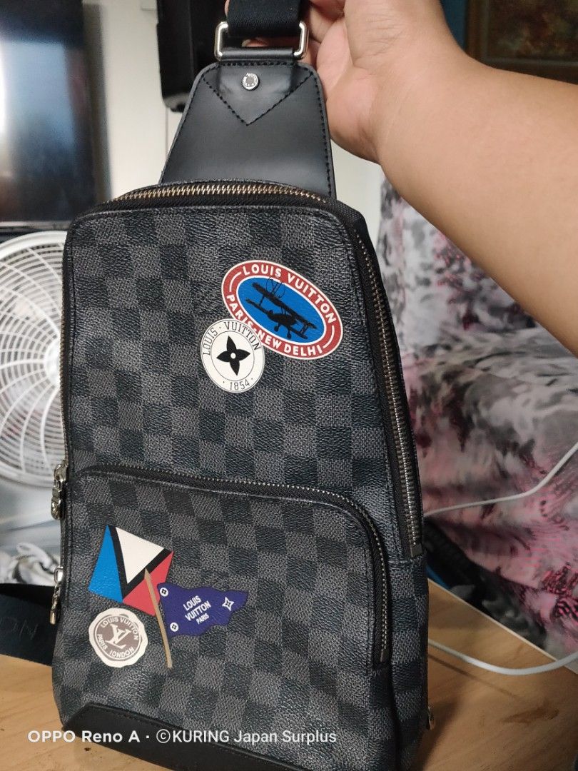 Louis Vuitton Damier Graphite Sling Bag (Category: Luxury Bags & Wallets) located in Batangas. Submitted by ems10. (Listing ID 1404810091, Image 1). Description: Authentic Louis Vuitton Damier Graphite sling bag. Features a checkered pattern with multiple patches. Includes a main compartment with a zipper closure and an adjustable strap. The interior has a small pocket and a Louis Vuitton label. Made in France. The bag has silver-tone hardware an
